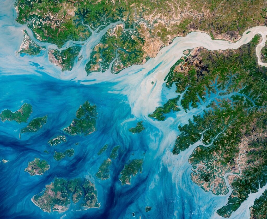 A satellite view of a branching river delta — the same fan-out pattern a traced transaction's funds leave across a blockchain